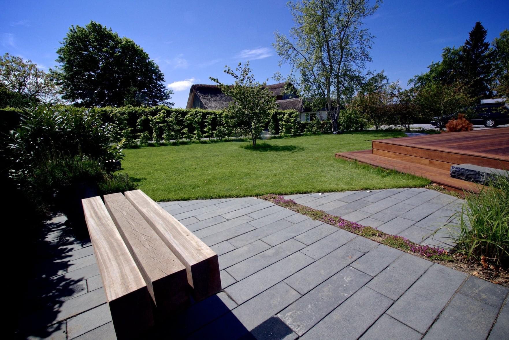 black limestone belægning med hårdtræ terrasse og bænk